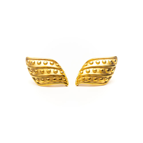Pair of gold wing-shaped earrings on a white background