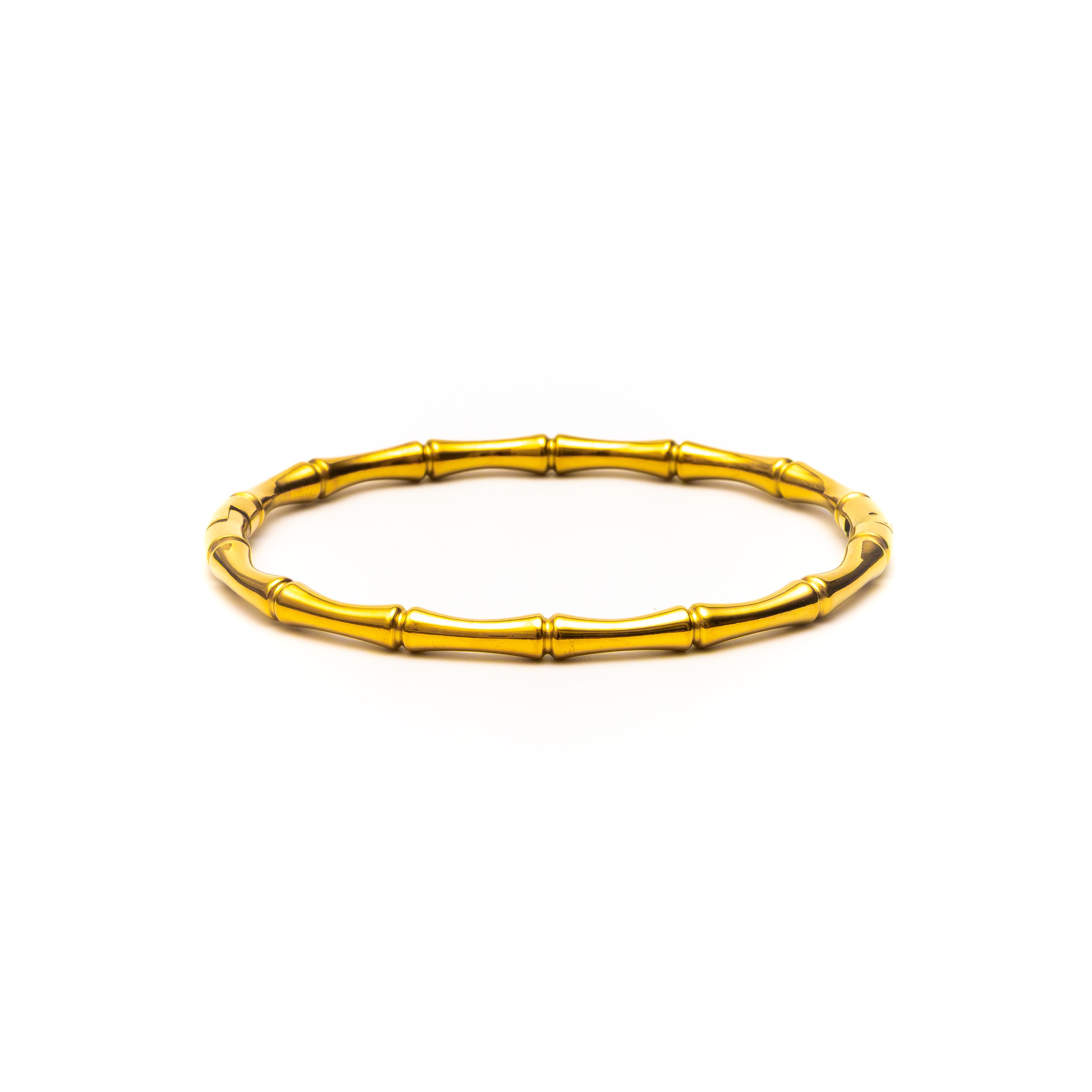 Gold bracelet with a bamboo design on a white background