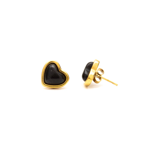 Heart-shaped black stone earrings with gold posts on a white background