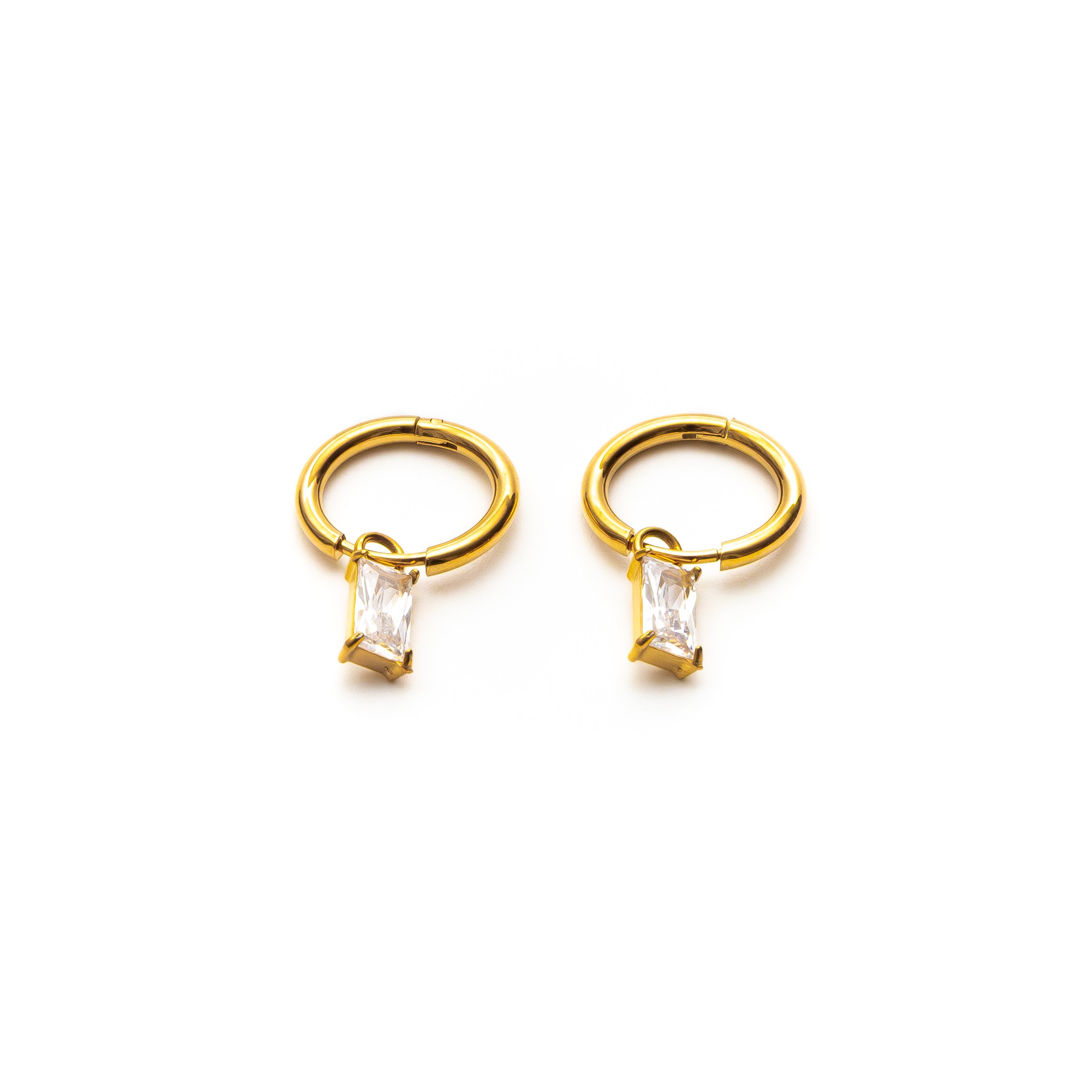 Pair of gold hoop earrings with clear gemstones on a white background