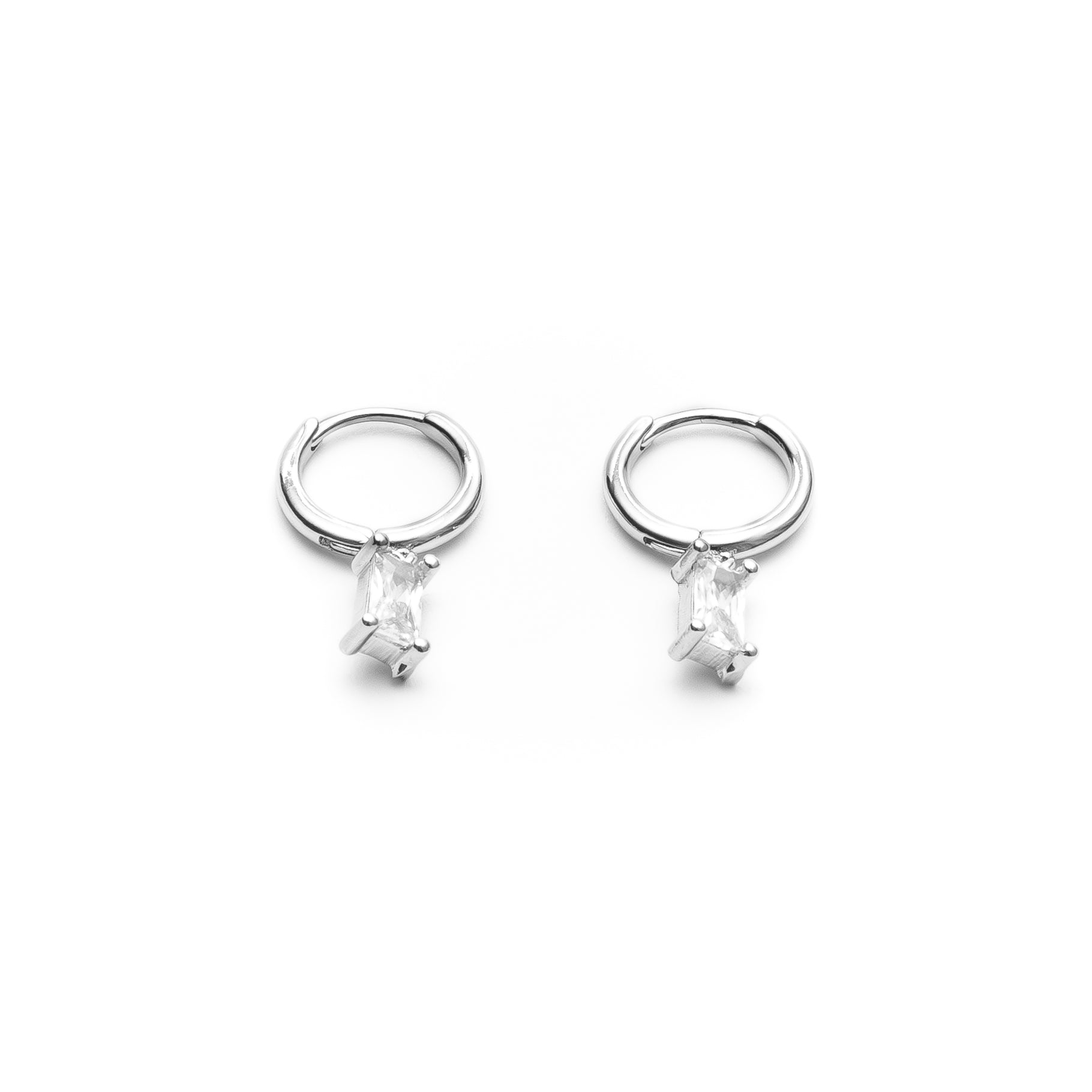 Pair of silver hoop earrings with clear gemstones on a white background