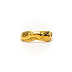Gold ring with wavy design on a white background