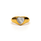 Gold ring with a heart-shaped stone on a white background