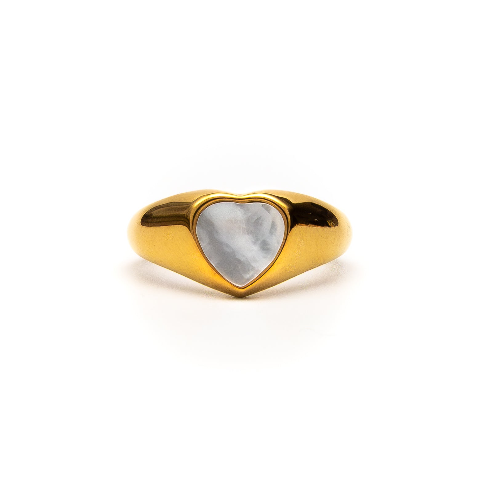 Gold ring with a heart-shaped stone on a white background