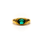 Gold ring with a green gemstone on a white background