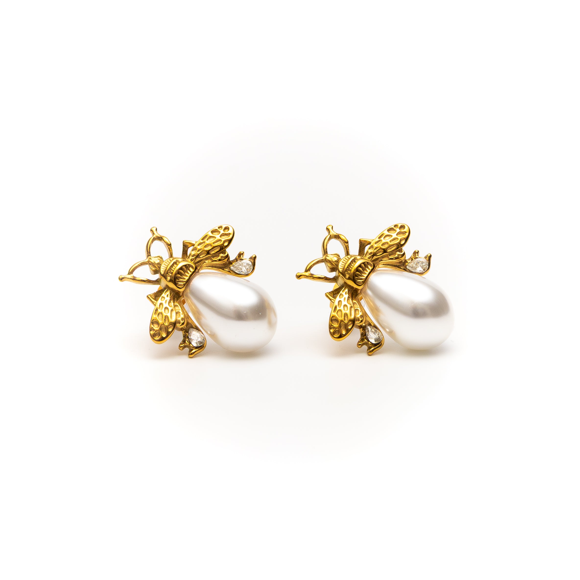 Gold bee earrings with pearl centers on a white background