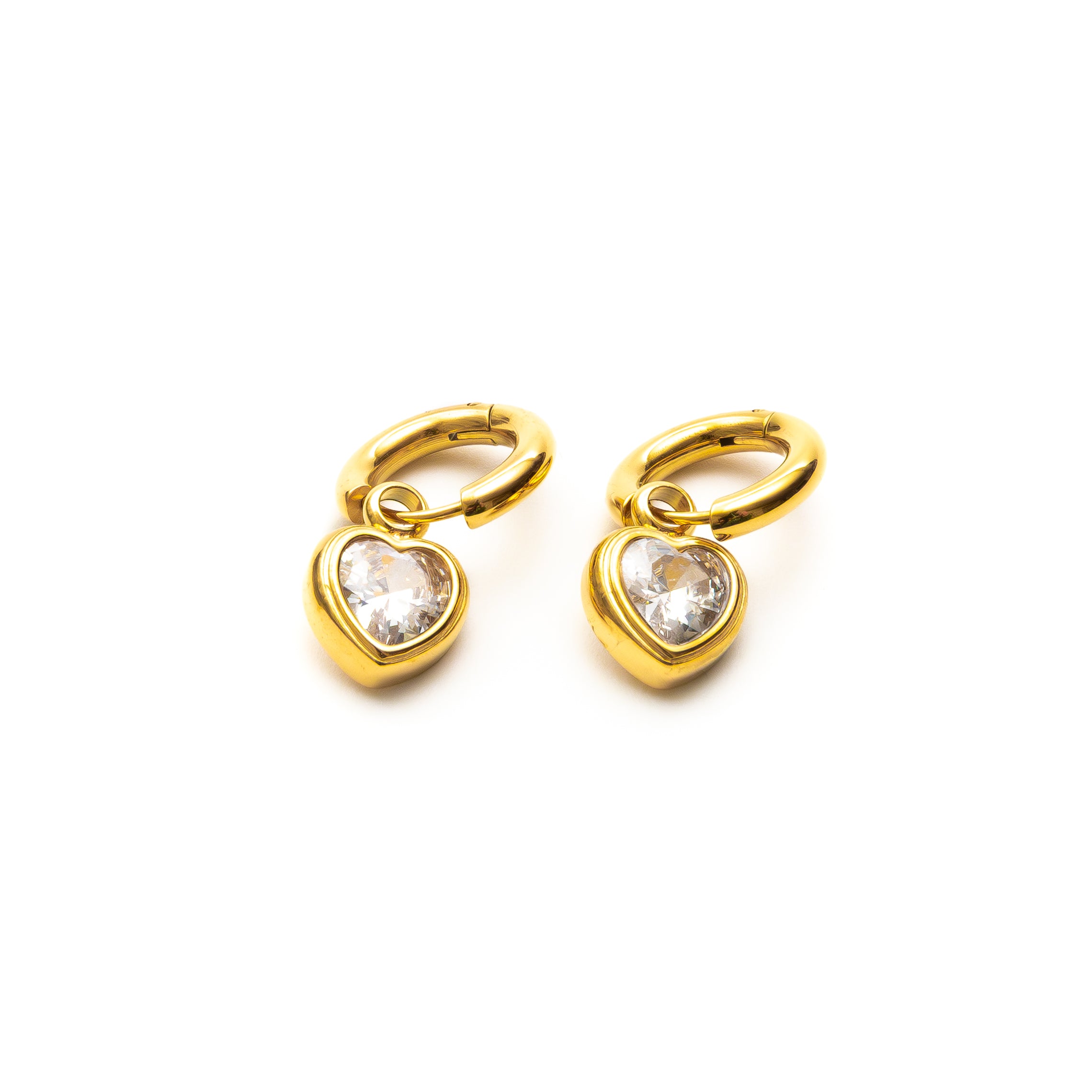 Gold heart-shaped earrings with clear gemstones on a white background