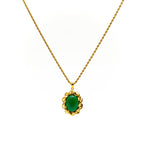 Gold necklace with a green pendant on a white background