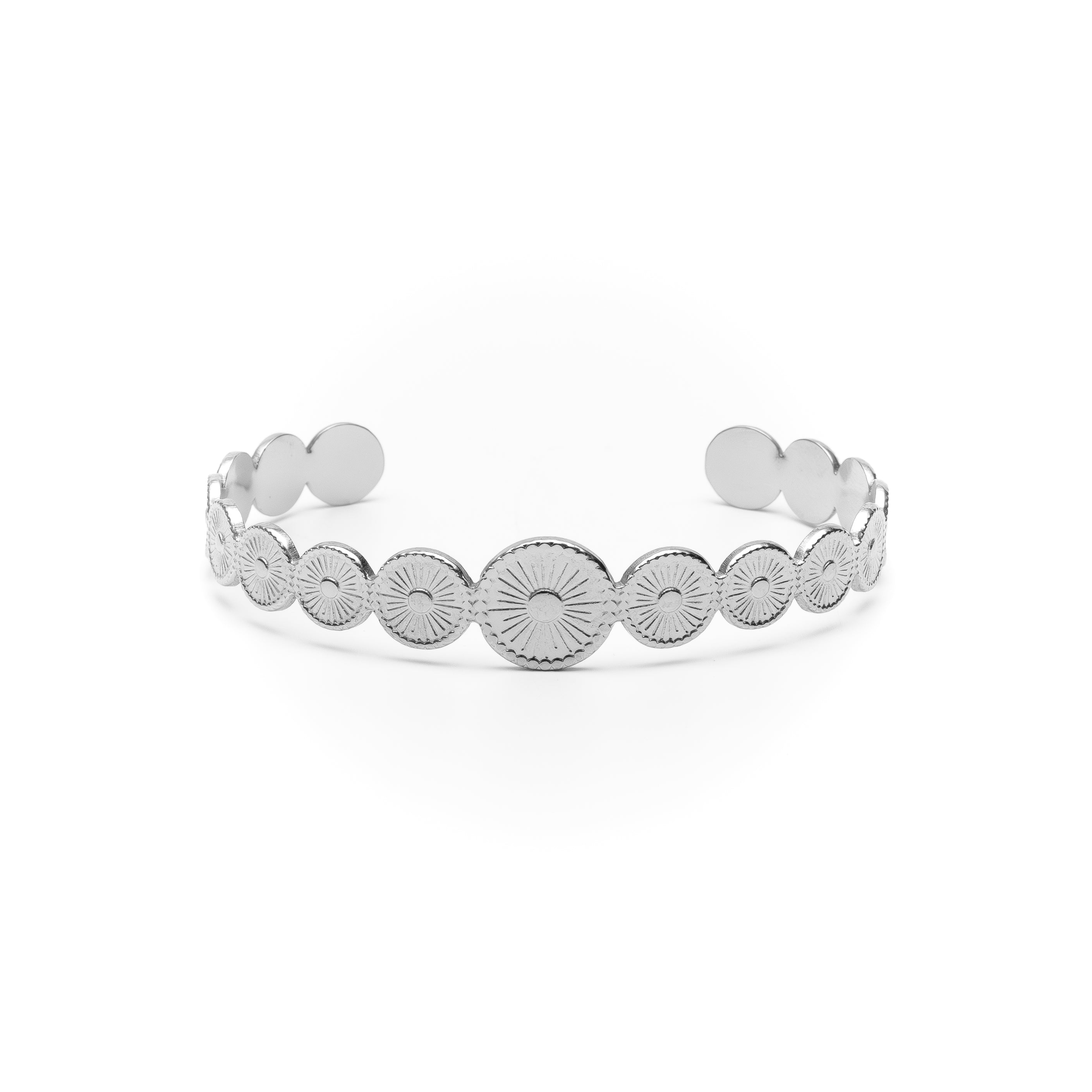 Silver bracelet with circular patterns on a white background
