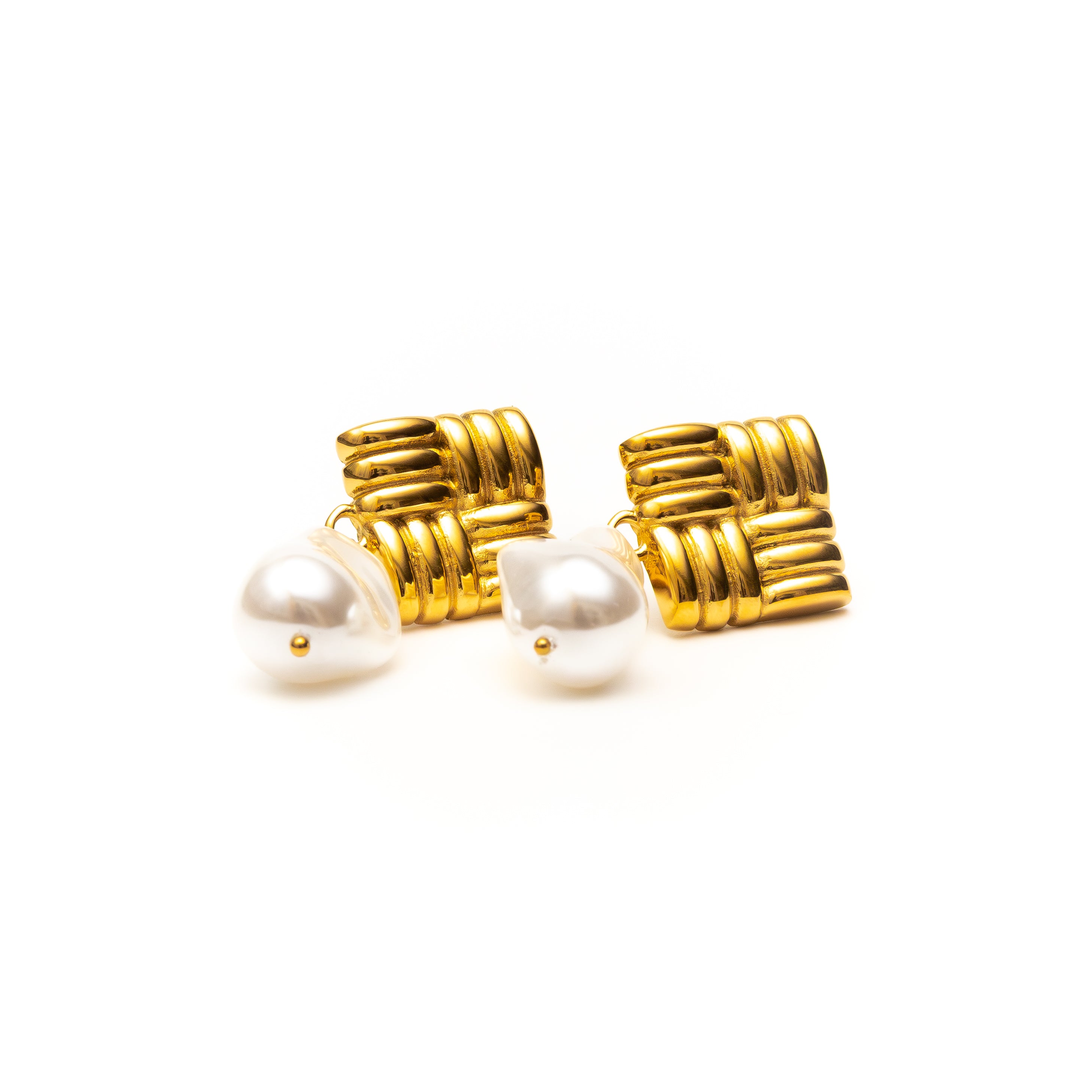 Gold earrings with pearl-like stones on a white background