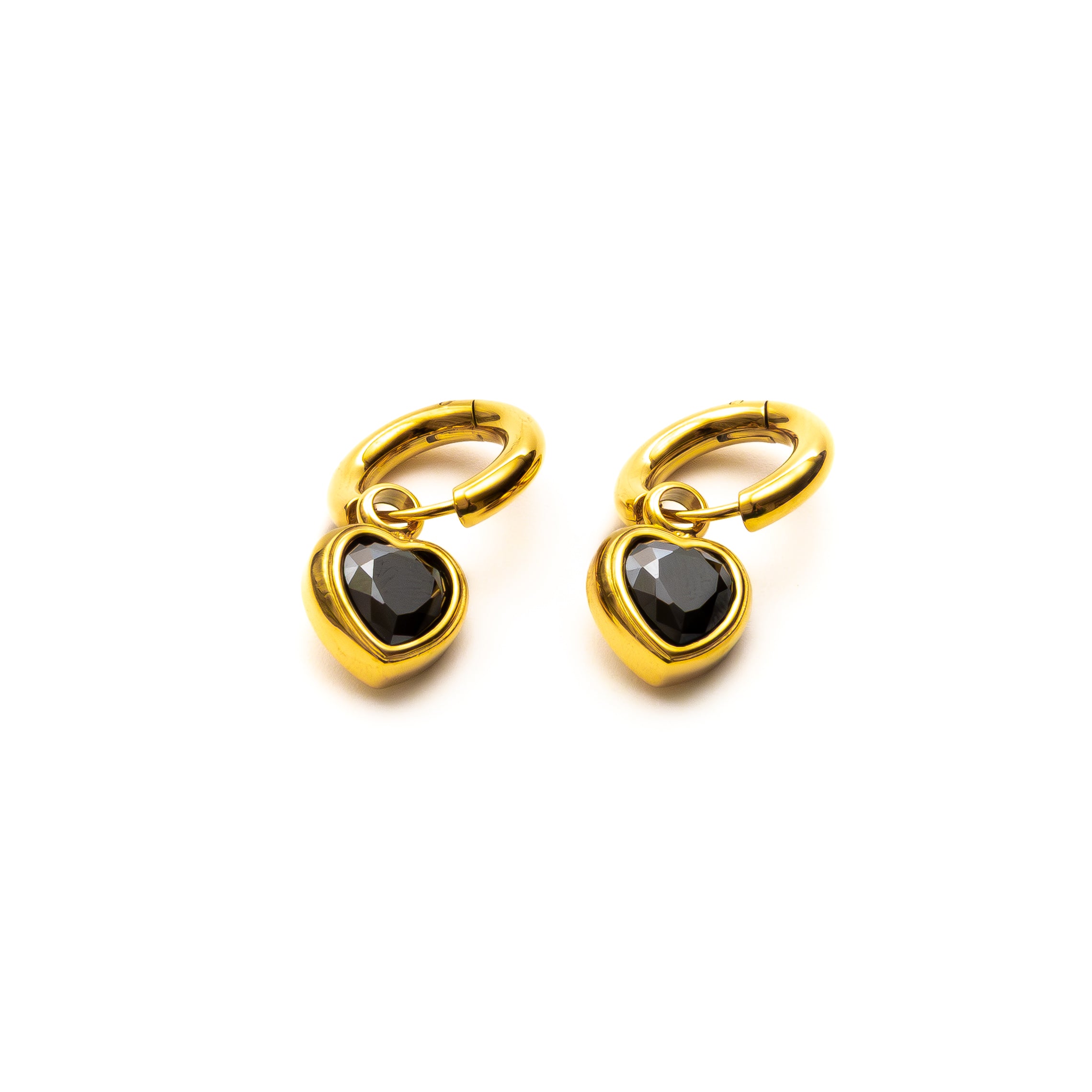 Gold hoop earrings with black heart-shaped stones on a white background