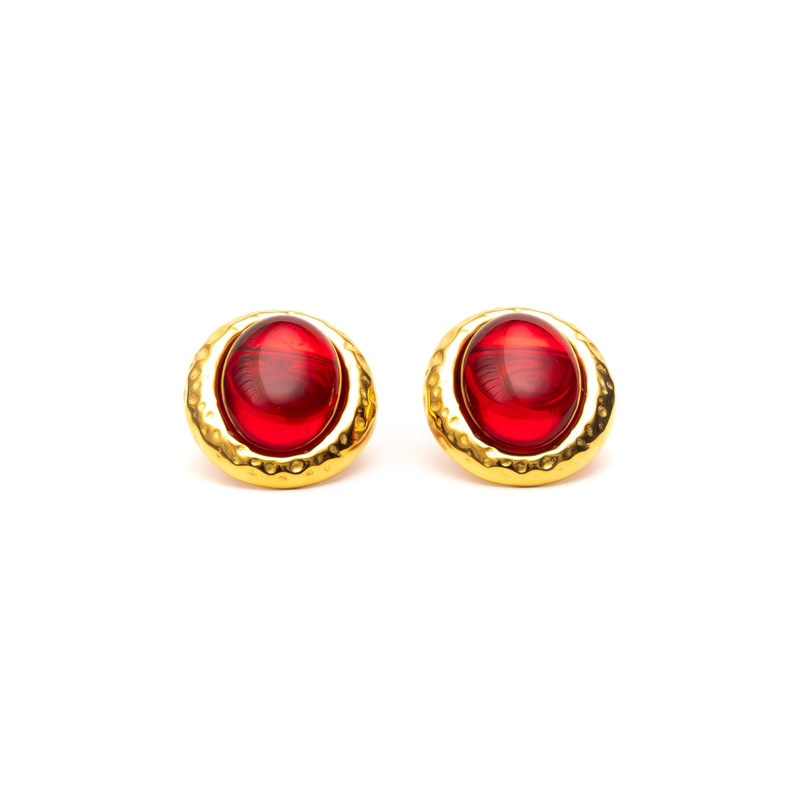 Pair of gold earrings with red stones on a white background