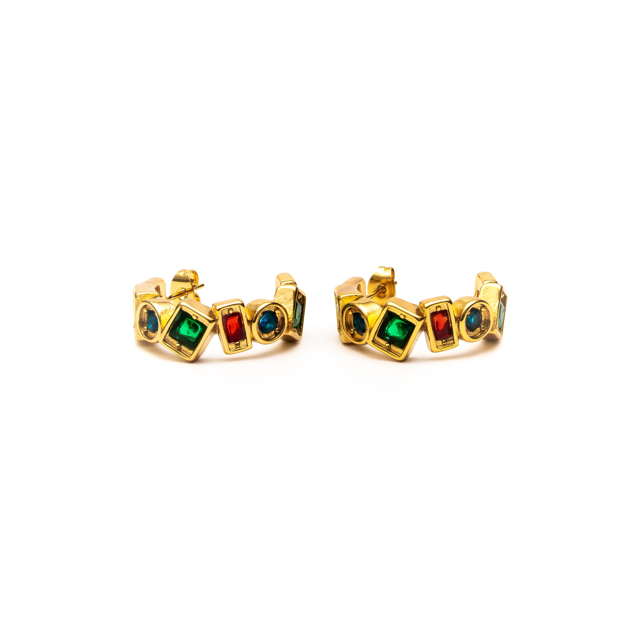 Gold rings with colored gemstones on a white background