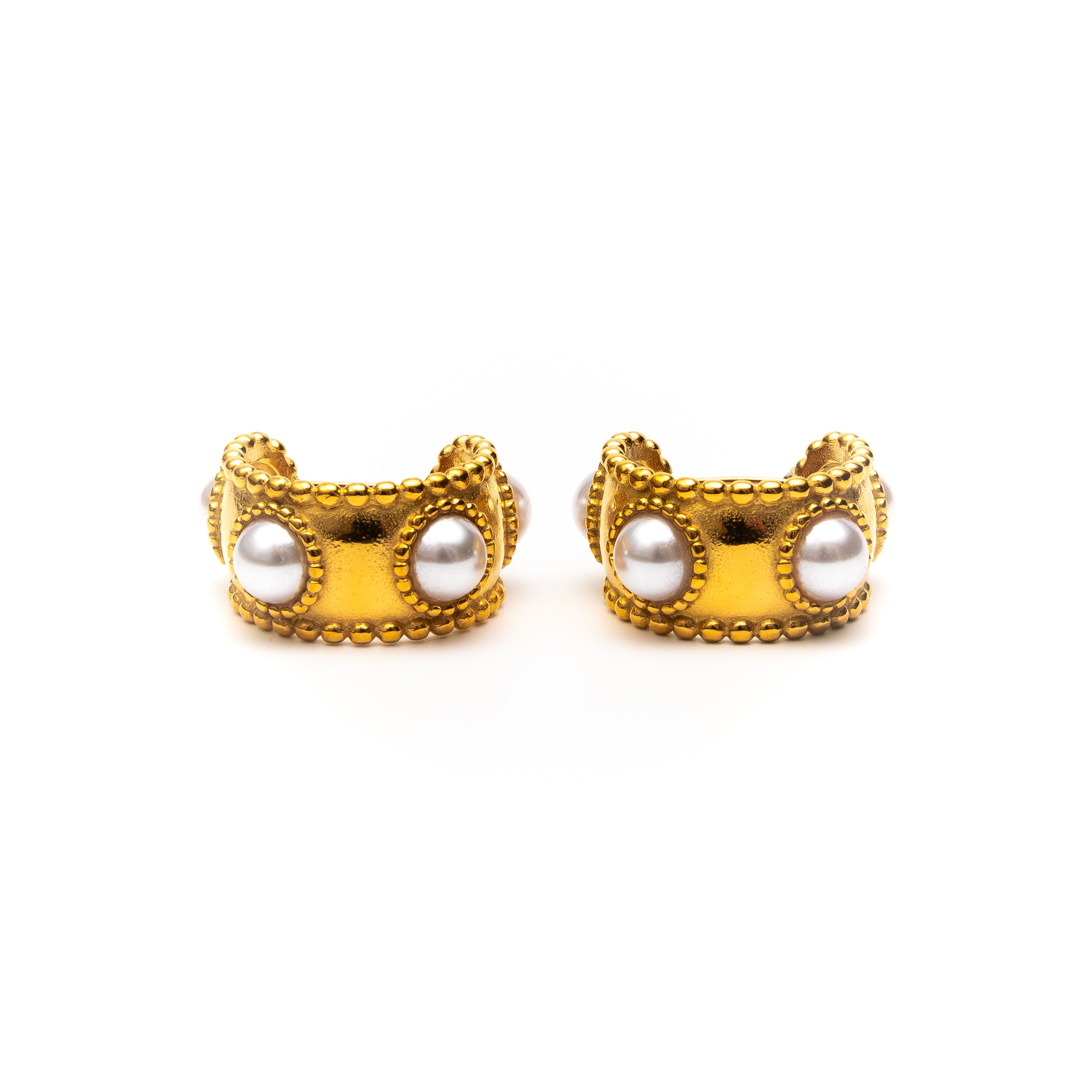 Pair of gold earrings with pearl-like centers on a white background