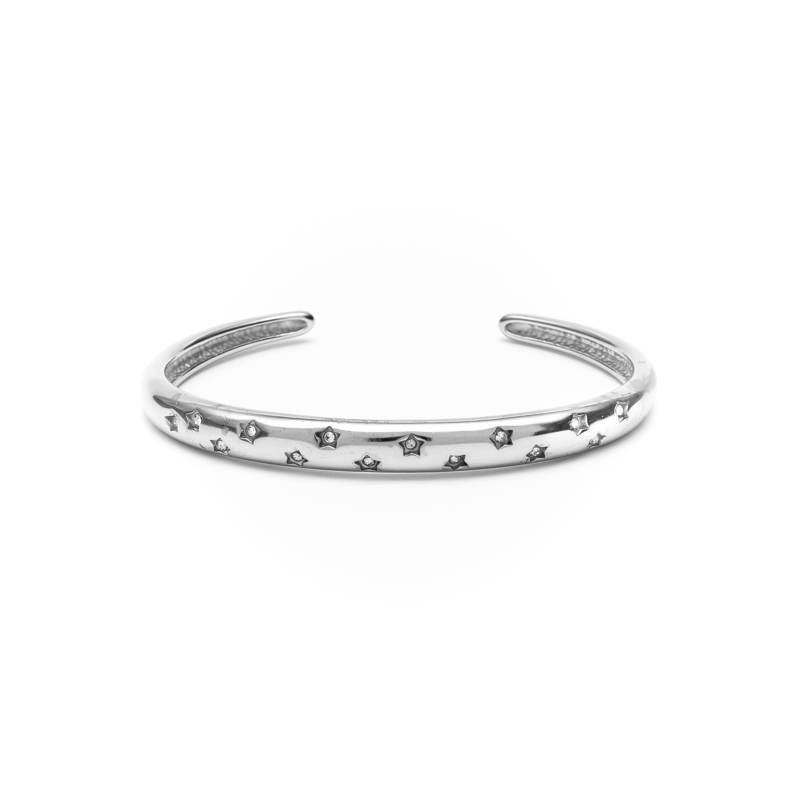 Silver bracelet with star patterns on a white background